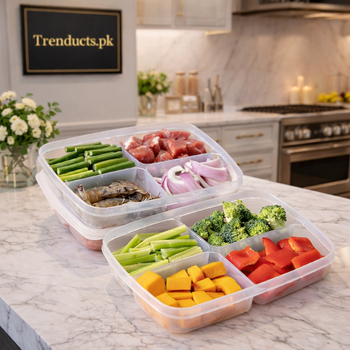 Transparent 4-compartment plastic food storage box filled with fresh vegetables and meat.