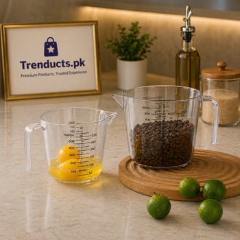 Transparent plastic measuring cups with black measurement markings, showing coffee beans and cracked eggs inside.