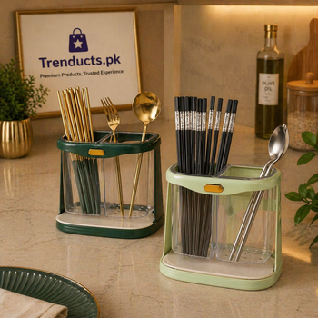 Two-slot white and gold cutlery holder with a drip tray, organized on a kitchen counter.