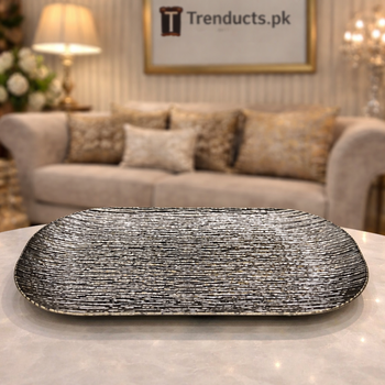Oval-rectangular silver fiber platter with linear ripple texture on a grey tiled floor - Trenducts Pakistan