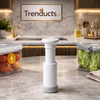 Trenducts handheld manual vacuum sealer pump in white being used to extract air from a food storage container for freshness.