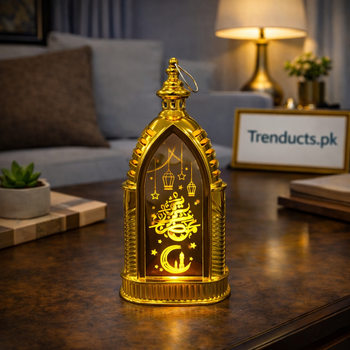 Gold arched LED metal lantern 11-14 held in hand showing mosque silhouette and Ramadan Kareem calligraphy.