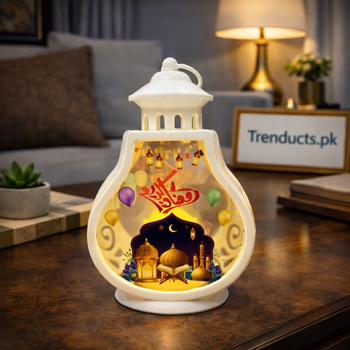 White bulb-shaped LED lalten with colorful Ramadan graphics and mosque art held in hand for size reference.