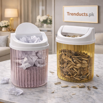 Two colored acrylic mini desktop bins on a white marble table, one filled with paper scraps and one with sunflower seeds.