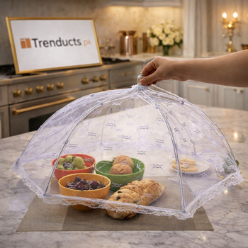 Foldable mesh food cover being held over a dining table with bowls of fruit and bread, transparent white mesh design.