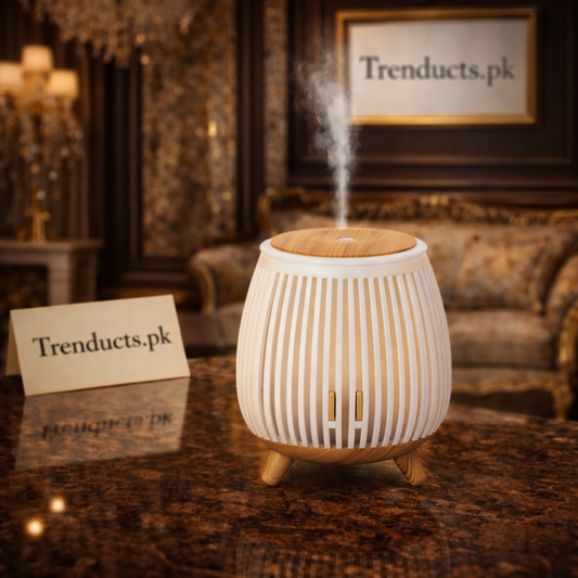 Minimalist light oak wood-grain aroma diffuser with a soft LED light ring emitting fine mist on a white marble surface.