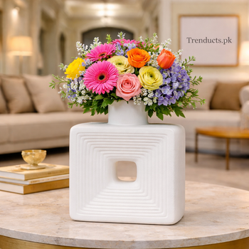 Minimalist textured matte white ceramic flower vase with a central square hole and ribbed pattern, displayed on a wooden shelf, suitable for modern Pakistani home decor.