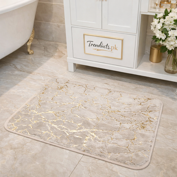 23-inch ultra-soft faux rabbit fur mat with gold stripes on a grey marble bathroom floor.