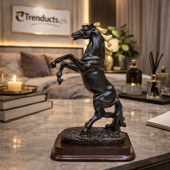 28cm matte black rearing horse statue standing on a modern white marble desk in a luxury office.