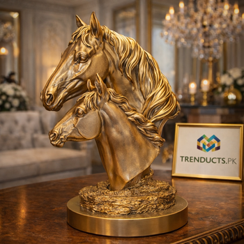 30cm wide golden duo horse head bust standing on a dark wood console table in a luxury home.