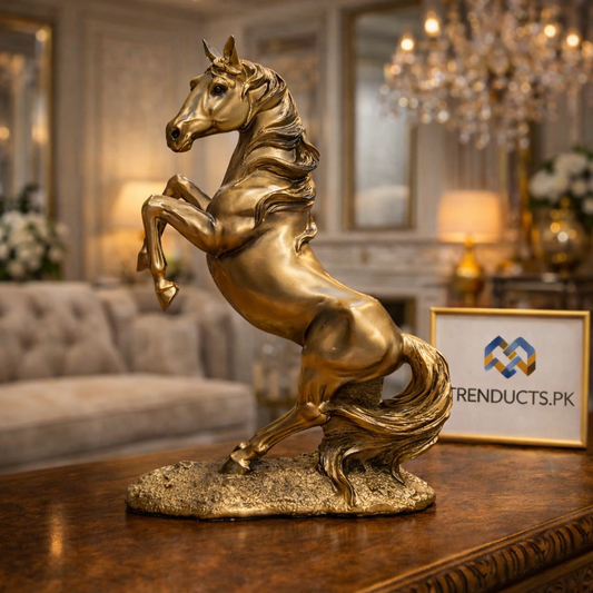 26cm shimmering golden horse sculpture standing on a white marble mantel in a luxury living room.
