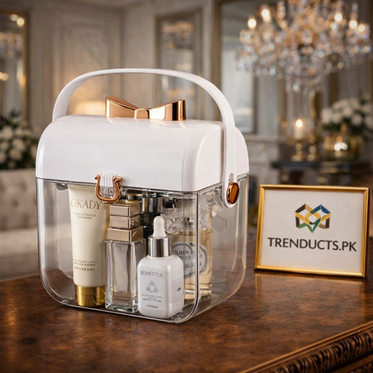 Clear acrylic vanity organizer with gold edges holding high-end lipsticks and brushes on a marble dressing table.