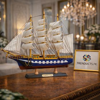 24cm royal blue and white sailing ship model on a glass shelf in a modern, luxury living room.