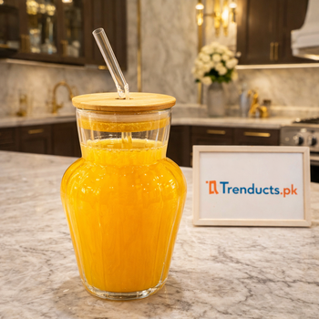 Large 1000ml aesthetic glass carafe with bamboo lid and straw filled with orange juice on a marble kitchen counter - Trenducts.pk