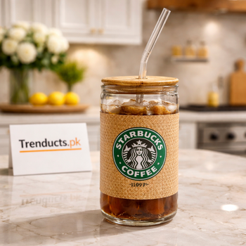 Starbucks branded glass tumbler with natural cork sleeve and glass straw on a grey background.