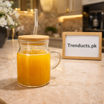 Aesthetic 450ml ribbed glass iced tea mug with handle, bamboo lid, and glass straw filled with juice on a marble counter - Trenducts.pk
