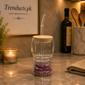 Ripple design double-walled glass mug with internal glitter, a bamboo lid, and a clear glass straw.