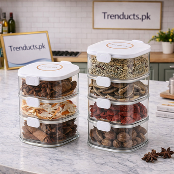 A vertical stack of clear acrylic spice containers with airtight lids on a modern marble kitchen counter.