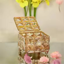 "Gold metal jewellery box with hand-set crystals and mirrored base."

"Luxury crystal vanity organizer for rings and necklaces - Trenducts Pakistan."