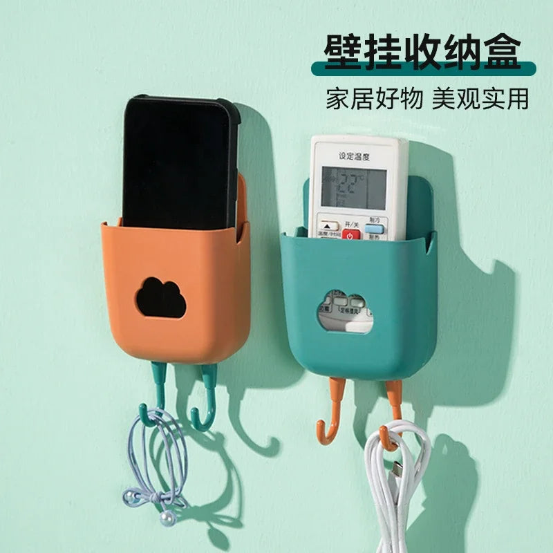 Multi-functional punch-free wall-mounted storage shelf for remotes and mobile phones in home and bathroom.