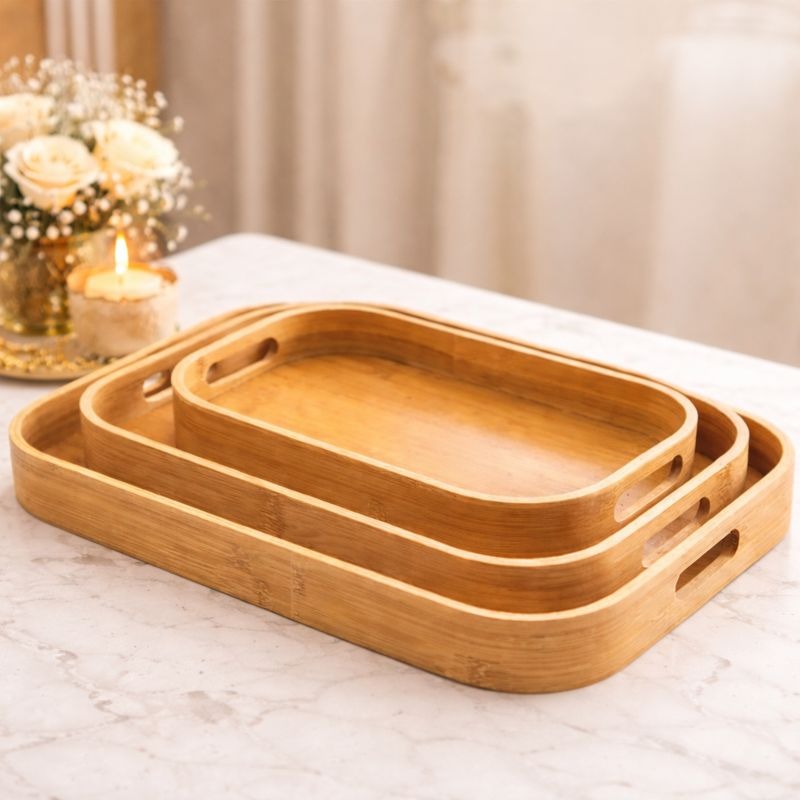 Set of three natural bamboo oval nesting trays with built-in handles