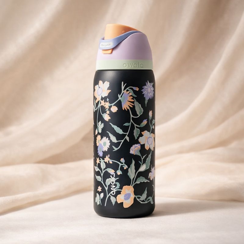 Owala FreeSip 32oz water bottle in Midnight Garden floral print with open lid showing built-in straw - Trenducts Pakistan