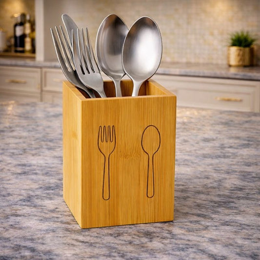 Square bamboo wooden utensil organizer with etched fork and spoon icons holding stainless steel cutlery on a wooden table - Trenducts Pakistan