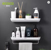 White wall-mounted bathroom shelf organizer with shampoo bottles and a hanging grey towel - Trenducts Pakistan