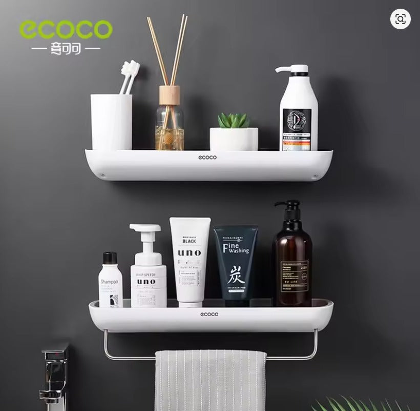 White wall-mounted bathroom shelf organizer with shampoo bottles and a hanging grey towel - Trenducts Pakistan