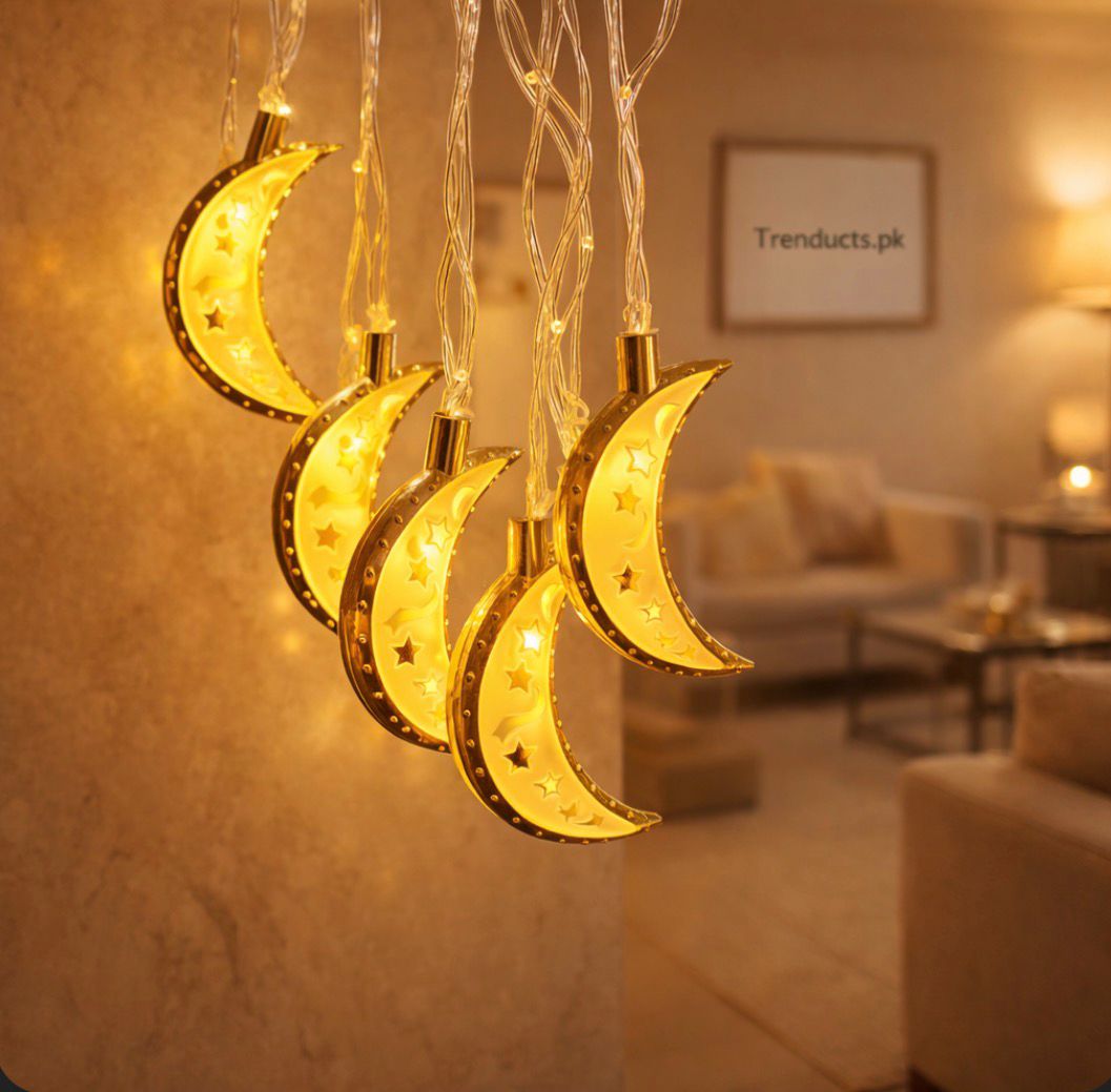 "Trenducts Ramadan string lights featuring orange crescent moon and mosque motifs with warm LED glow."

"Close-up of purple Islamic lantern (fanous) string lights for Eid home decoration."