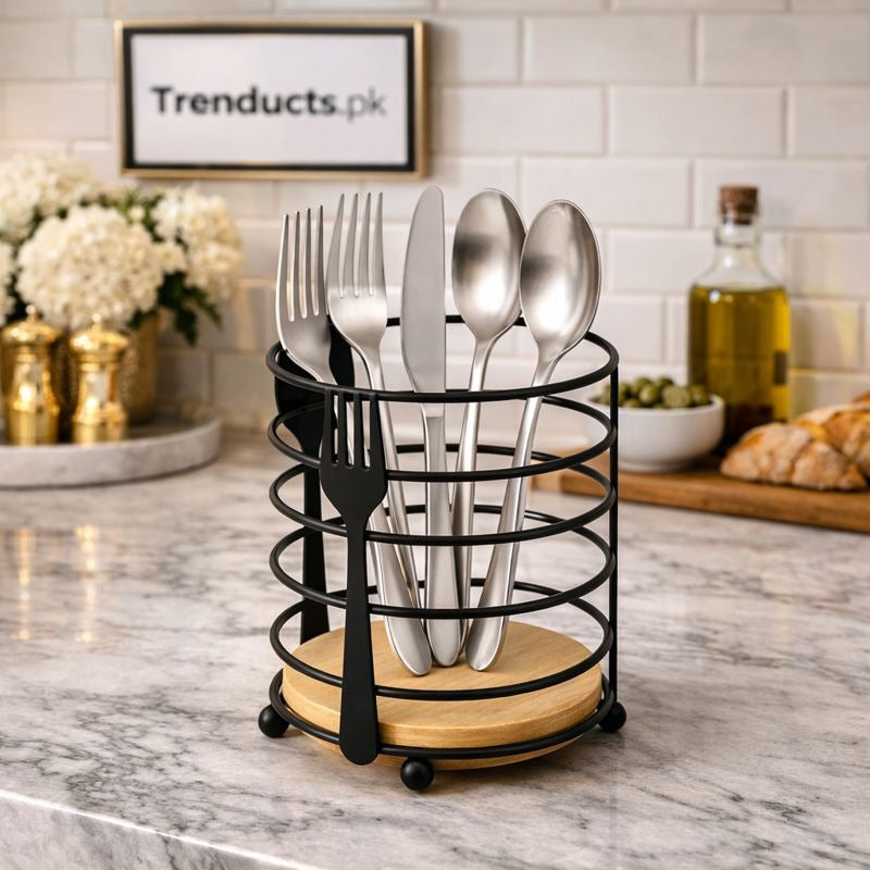 "Modern metallic wire spoon holder with a solid oak wood base on a kitchen counter."

"Artisan matte black cutlery organizer for spatulas and kitchen tools in Pakistan."
