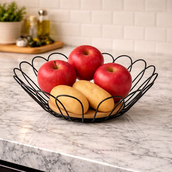 "ModLeaf designer leaf-shaped metallic fruit basket with a solid oak wood base."

"Aesthetic matte black leaf-wire fruit bowl for modern dining table centerpiece in Pakistan."