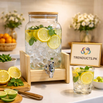 A 2-liter glass juice dispenser with a bamboo lid and stainless steel tap sitting in an elevated bamboo wooden frame.