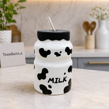 Cow print ceramic milk mug fully visible with lid and glass straw