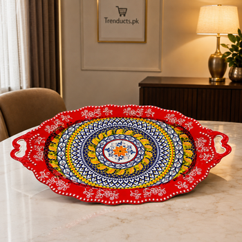 Large red kebab and mandi serving platter on a dining table