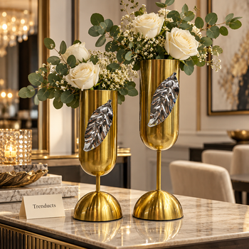 Gold goblet metal vase with silver leaf with white roses on a dining sideboard - Trenducts