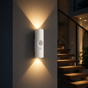 White motion sensor night light glowing on a wall beside a staircase at night - Trenducts