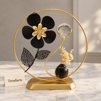 Crystal Ball Table Decor with black flower and gold ring on a white marble studio surface | Trenducts