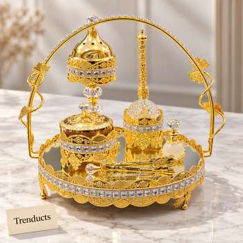 Gold ornate decorative tabletop set on a white marble studio surface | Trenducts