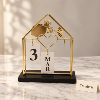 Metal Home Calendar in gold on a white marble studio surface | Trenducts
