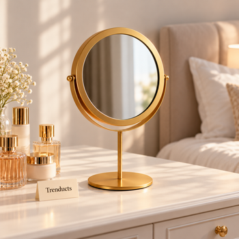 Gold round metal mirror on a dressing table in a bedroom | Trenducts