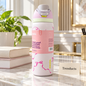 Owala Water Bottle 32 oz in a white body with a pink ribbon bow print on a bright desk in a luxury home | Trenducts