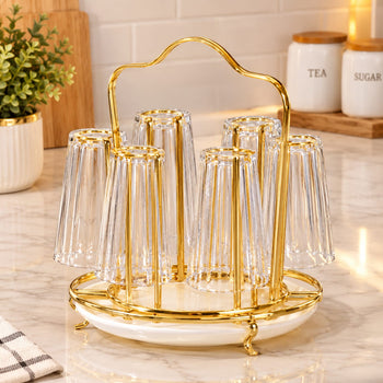Gold Glass Stand holding six clear ribbed glasses on a marble kitchen counter | Trenducts