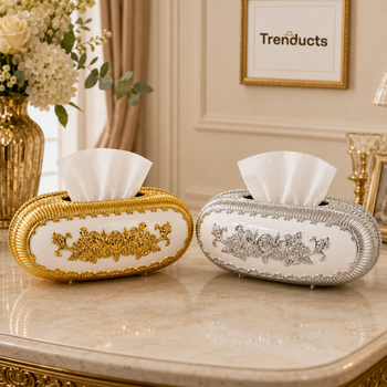 White oval tissue boxes with gold and silver floral finishes